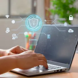 Hands typing on laptop with digital security icons overlay, including a shield, lock, cloud storage, and binary code, representing protected business communications and cybersecurity